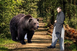 A man and a bear are standing in the woods