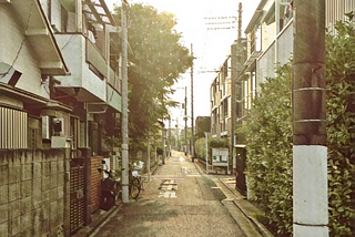 A slightly filtered image of a small neighborhood street in Japan.
