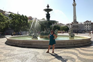 Woman in front of a fountain.