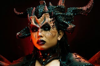 Woman Wearing a Devil Costume with Horns More info Share