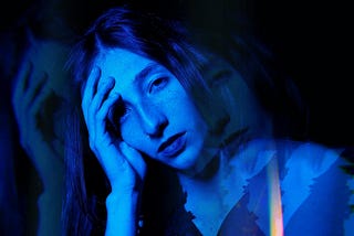 A Moody Blue Double Exposure Photograph of Woman at Night