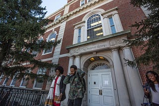 Several people outside the Founder’s Library in Howard University.