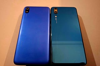 Two old smartphones lying side by side on a table.
