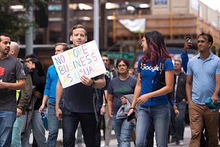 Tech workers and others arrive as Amazon Employees for Climate Justice lead a walkout and rally at the company’s headquarters