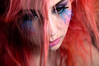 Girl with pink hair and blue eyelashes