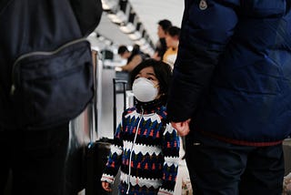A child wears a medical mask out of concern over the Coronavirus at the JFK terminal that serves planes bound for China.