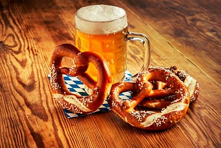 A giant frothy beer and soft pretzels