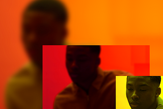 In the lower left corner of this photo is a small rectangle with closeup of a depressed-looking Black person against a yellow background. A larger, zoomed-out, slightly blurry version of the same image, but colored red, is to the left of the small rectangle, which overlaps it slightly. The background is an even more zoomed-out and blurry version of the pic, colored orange.