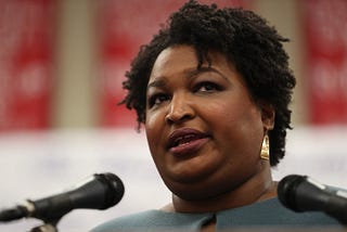A closeup photo of Stacey Abrams speaking at an event.
