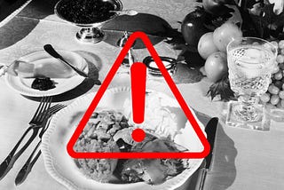Black-and-white vintage photo of a Thanksgiving dinner; overlaid on it is a red triangle with an exclamation mark.