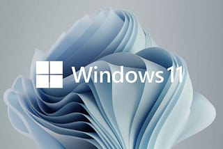 The Windows 11 logo with a wallpaper like folding blue fabric