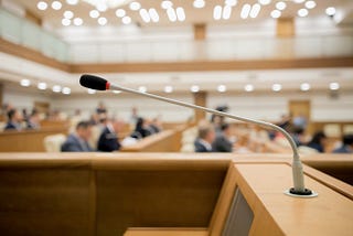 Photo of Congress in session with an empty mic at the podium.