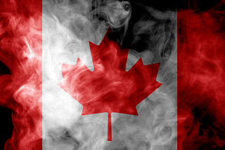 Canadian flag surrounded by white smoke