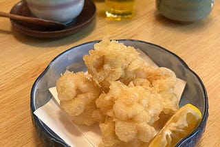 Tempura on plate with lemon.