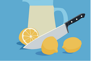 A knife cuts a lemon in half, while another lemon is nearby, awaiting its fate. A jar of lemonade is in the background.