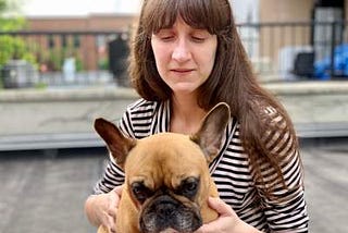 Sabrina, Principal Design Strategist at &Partners, holding a cute dog.