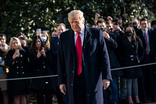 Donald Trump turns from reporters as he exits the White House to walk toward Marine One on the South Lawn on January 12, 2021