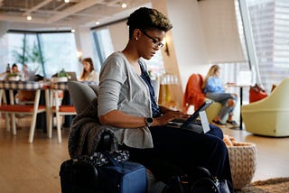 A woman working on her iPad at The Wing, a women’s co-working space.