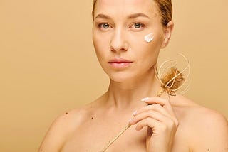 A woman holding a facial scrubbing instrument. botox, health and Beauty