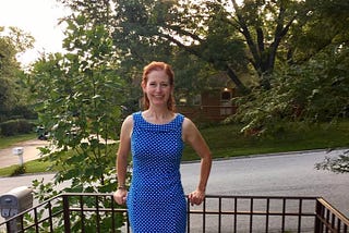 Photo of author standing outside of her house.