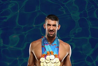 A picture of Michael Phelps, the most decorated Olympian swimmer of all time, wearing and holding all the medals he’s won over the span of his career.