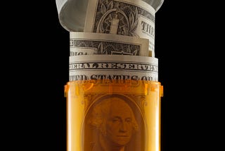 A US dollar bill rolled up in a prescription bottle.