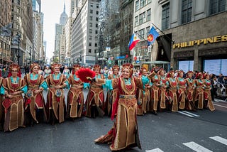 Dancers wearing Spanish costumes marching down 5th Avenue in New York for Hispanic Heritage Month.