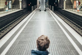 Little boy on an empty subway platform.