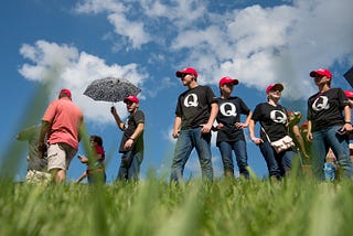 Supporters of President Donald Trump wearing ‘QAnon’ t-shirts wait in line before a campaign rally at Freedom Hall on 10/1/18