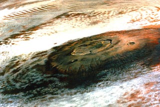 Olympus Mons, a Martian volcano, photographed by the Viking 1 spacecraft from 5000 miles away.