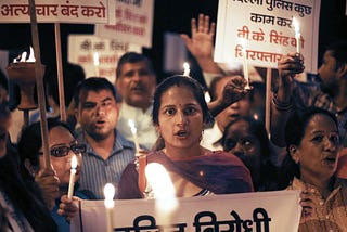 A photo of Indian protestors holding a candlelight march.