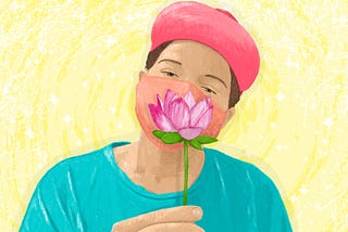 A short-haired person with light brown skin wearing a pink baseball cap, a light teal shirt, and a sherbet-orange face mask, holds a lotus flower in front of their lower face.