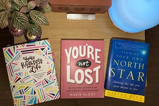 Flat lay of three books: Your Brightest Life Journal, You’re Not Lost, and Finding Your Own North Star.
