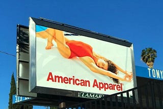 An American Apparel Ad with a woman in a red, single-piece swimsuite