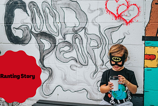 little boy with batman mask and a coffee cup in hand sits by a white brick wall that reads “Good People”