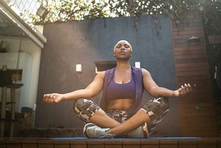 Woman meditating in the backyard.
