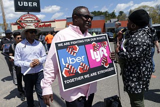 Uber and Lyft drivers protest outside the Uber offices in Saugus, MA.