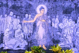 Purple-fluorescent wall painting of ‘The Buddha preaching The Dhamma’ at Dhamma Igatpuri