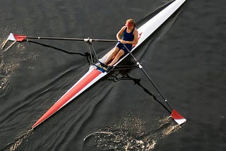 A woman rowing a kayak.