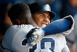 NY Yankees teammates Gleyber Torres and Cameron Maybin hug as they celebrate a two run home run against the Toronto Blue Jays