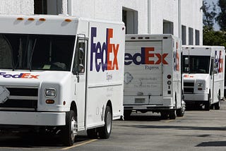 FedEx trucks lined up on a street