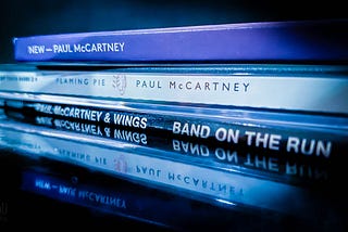 A stack of Paul McCartney albums from various decades