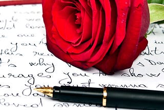 Love letter, red rose and fountain pen.