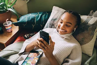 Young woman smiling while on the phone.