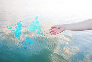 A photo of a hand extending to water with three abstract triangles.