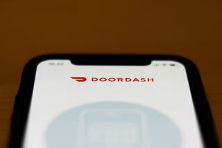 The Doordash app logo is seen on an iPhone screen.