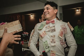 Handsome man with lots of money stuck to him