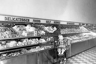 People picking up treats at a self-serve delicatessen in Bergs Supermarket, circa 1950.