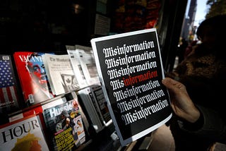 Misinformation newsstand in Manhattan. Person holds magazine that has “Misinformation” on the cover.