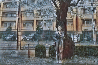 A masked woman standing beneath a flowering tree.